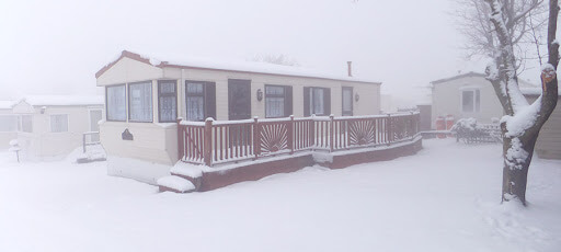 static caravan covered in snow