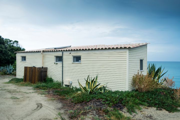 Static caravans on the edge of a cliff looking over the sea