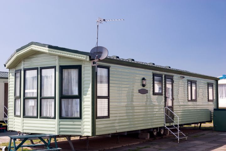 white static caravan with dark grey windows and door