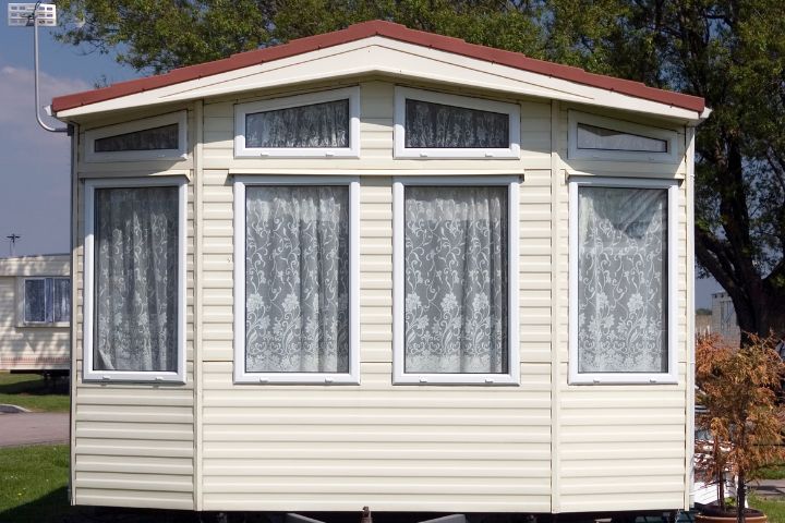 Front view of a static caravan with net curtains