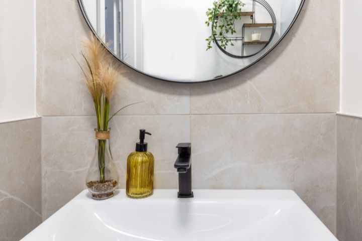 Bathroom sink and mirror with soap and vase