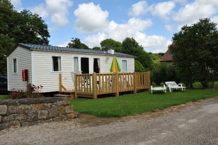 Static caravan with an outside decking, parasol and deck chairs