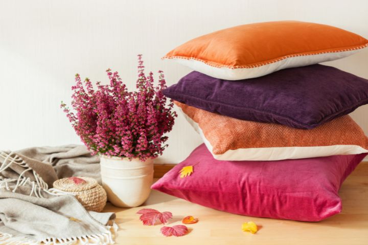 Cushions and a lavender plant on a surface