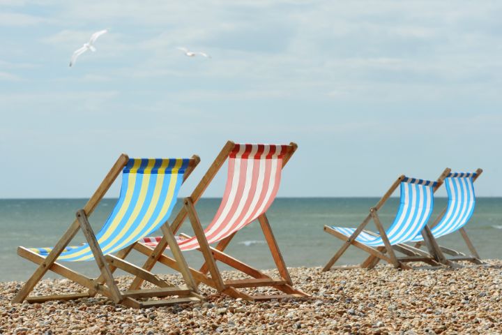 Deck chairs on stony beach