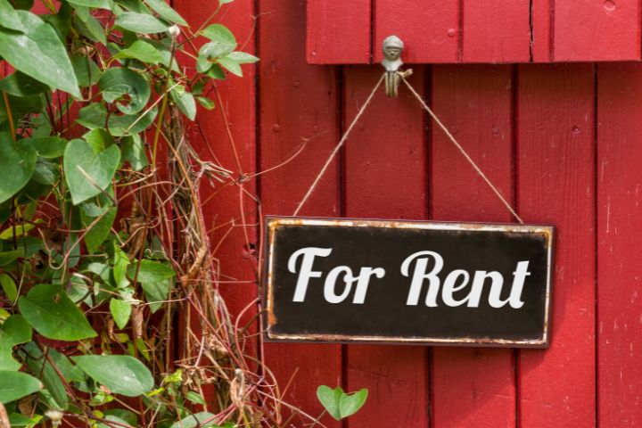 Red fence with for rent sign