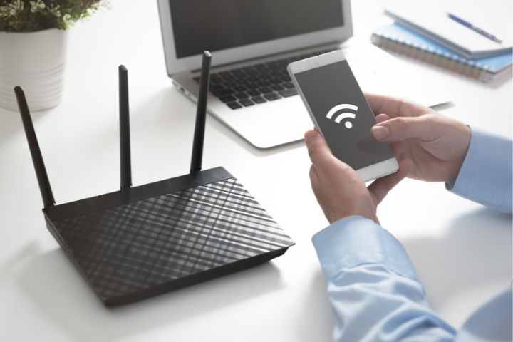Wifi router and mobile phone showing wifi symbol