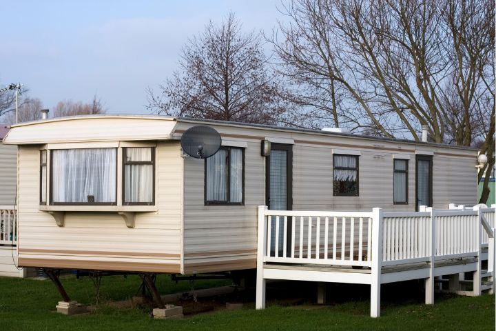 Static caravan with decking and a satellite dish