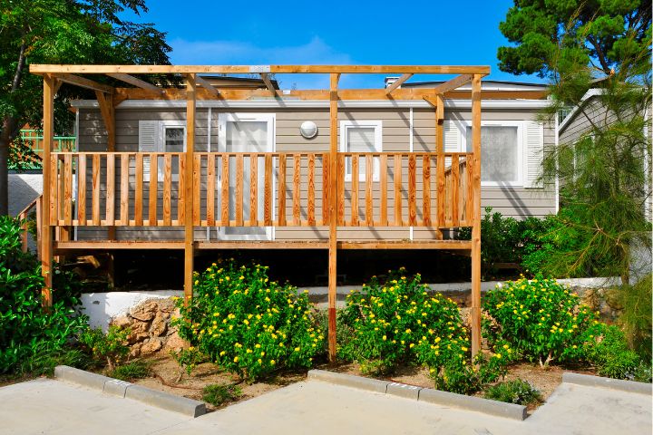 Static caravan with wooden decking and plants out the front