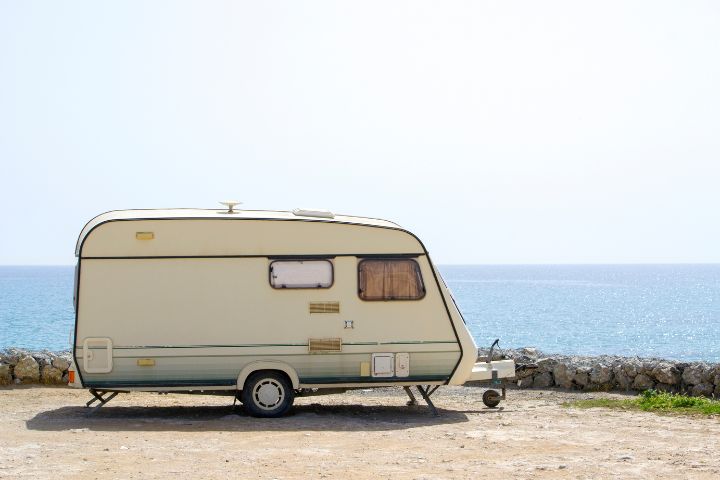 Touring caravan pitched in front of the seaside