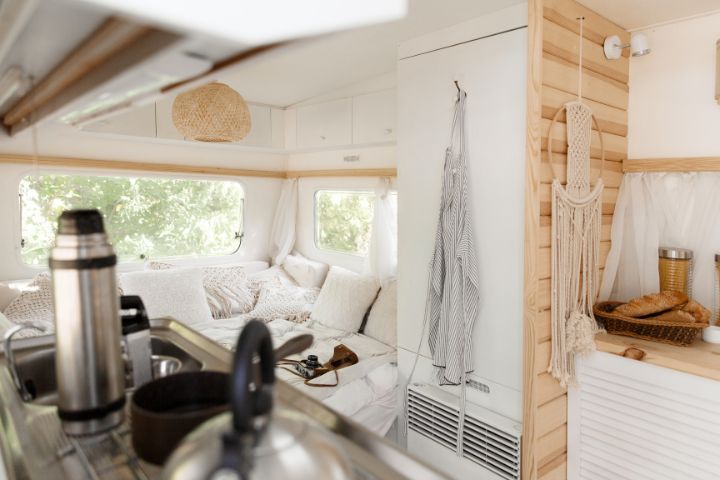 Inside of a caravan, showing the licing area and kitchen area