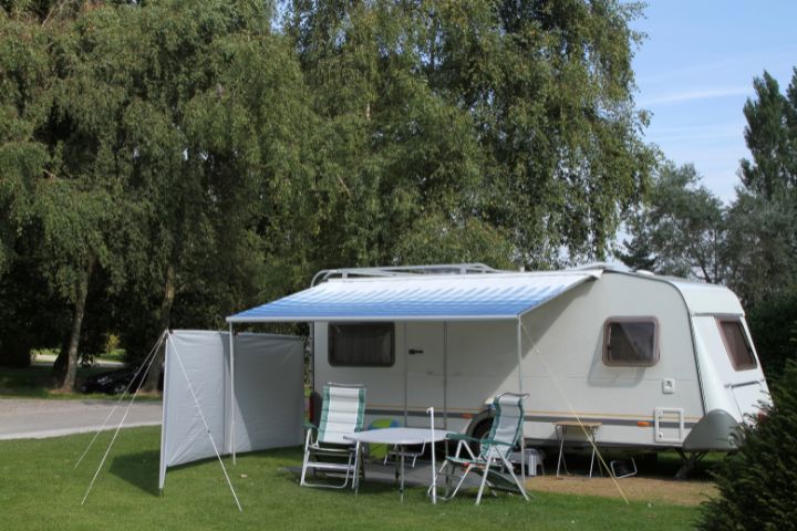 Touring caravan with an awning and table and chairs out front