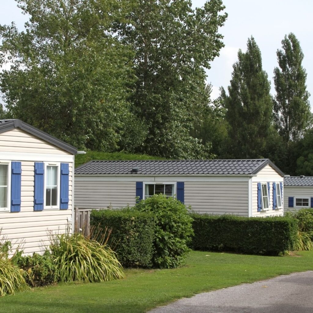 static caravan homes with blue window shutter details