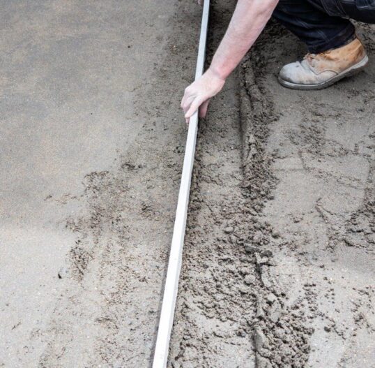 construction worker laying groundworks